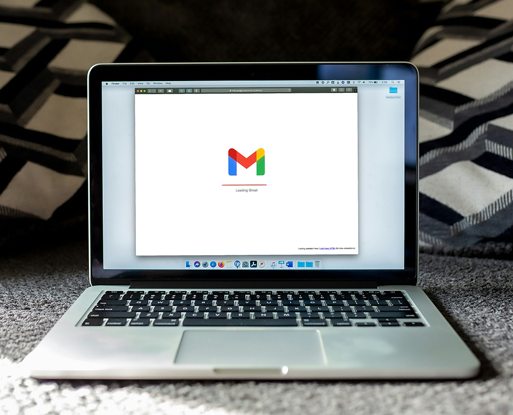 A laptop displaying the Gmail loading screen, representing the power of email marketing in nurturing leads and driving customer engagement.