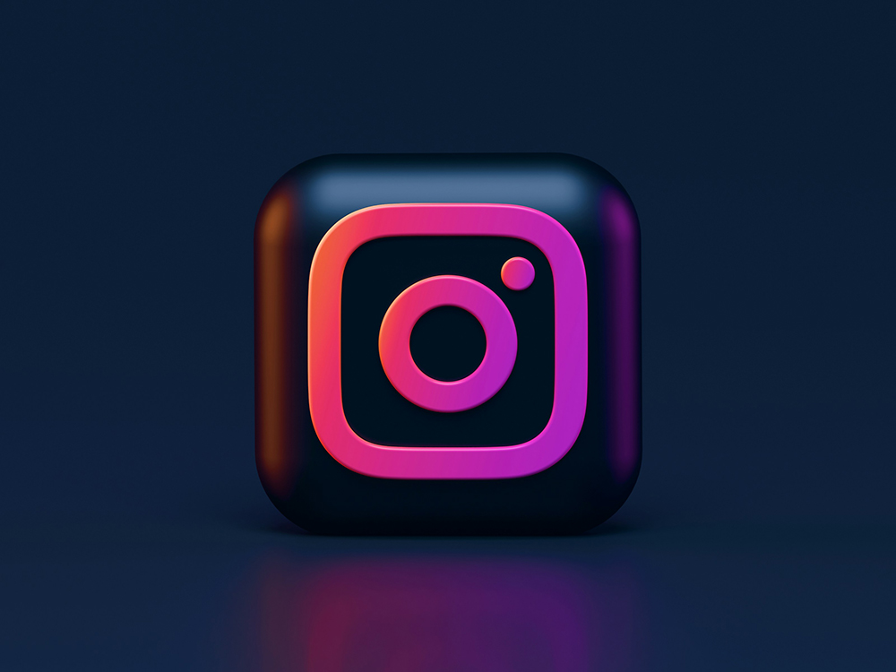 3D-rendered Instagram logo with a neon glow, representing the impact of social media marketing on brand visibility and online sales.