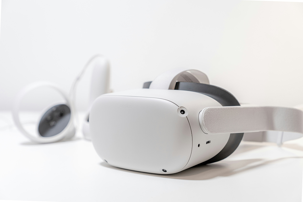 A modern white virtual reality (VR) headset with controllers, symbolizing the rise of immersive experiences in web design and digital interaction.