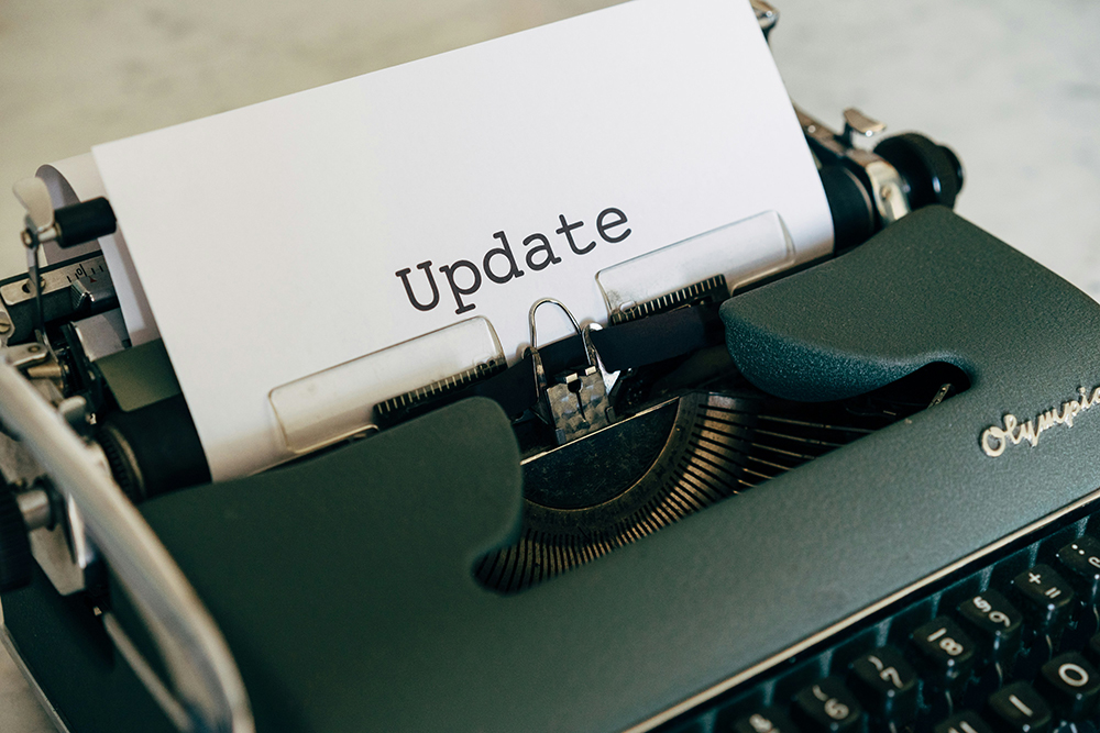 A vintage typewriter with a sheet of paper displaying the word 'Update,' symbolizing website software and plugin updates.