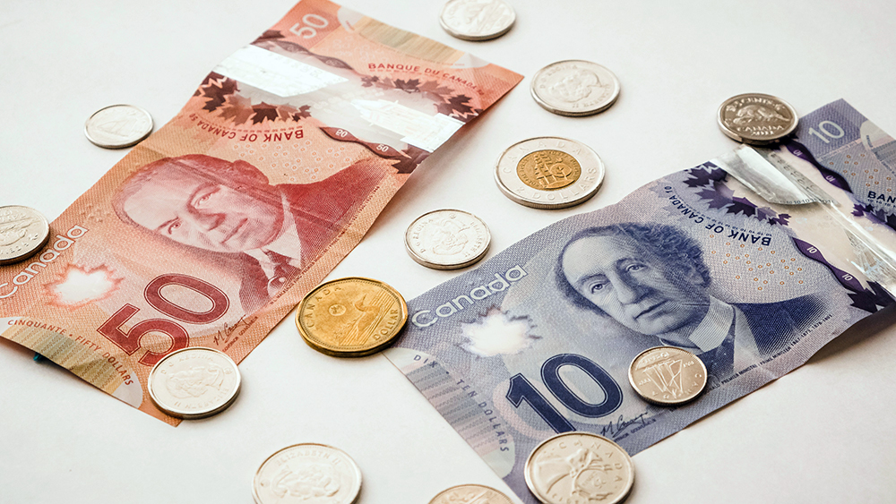 Canadian currency, including $50 and $10 bills, with various coins scattered around, symbolizing financial decisions.