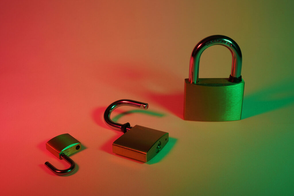 Three padlocks in varying states of lock and unlock, symbolizing stages of website security and vulnerability.