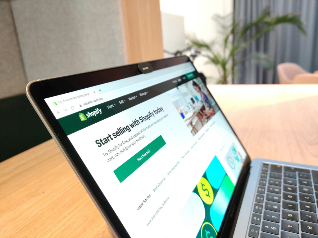 Laptop screen displaying the Shopify homepage with the message ‘Start selling with Shopify today’ promoting its eCommerce platform.