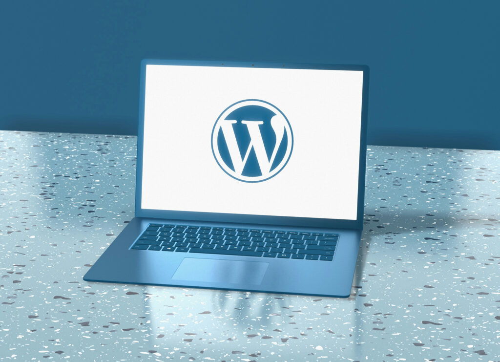 Laptop displaying WordPress logo on screen, representing modern website builders and CMS platforms